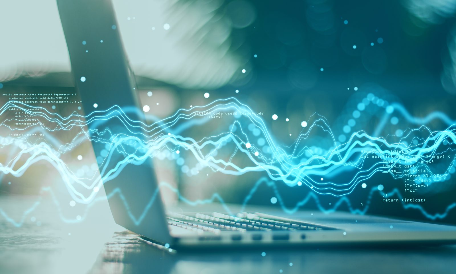 Glowing lines of data flowing across a laptop
