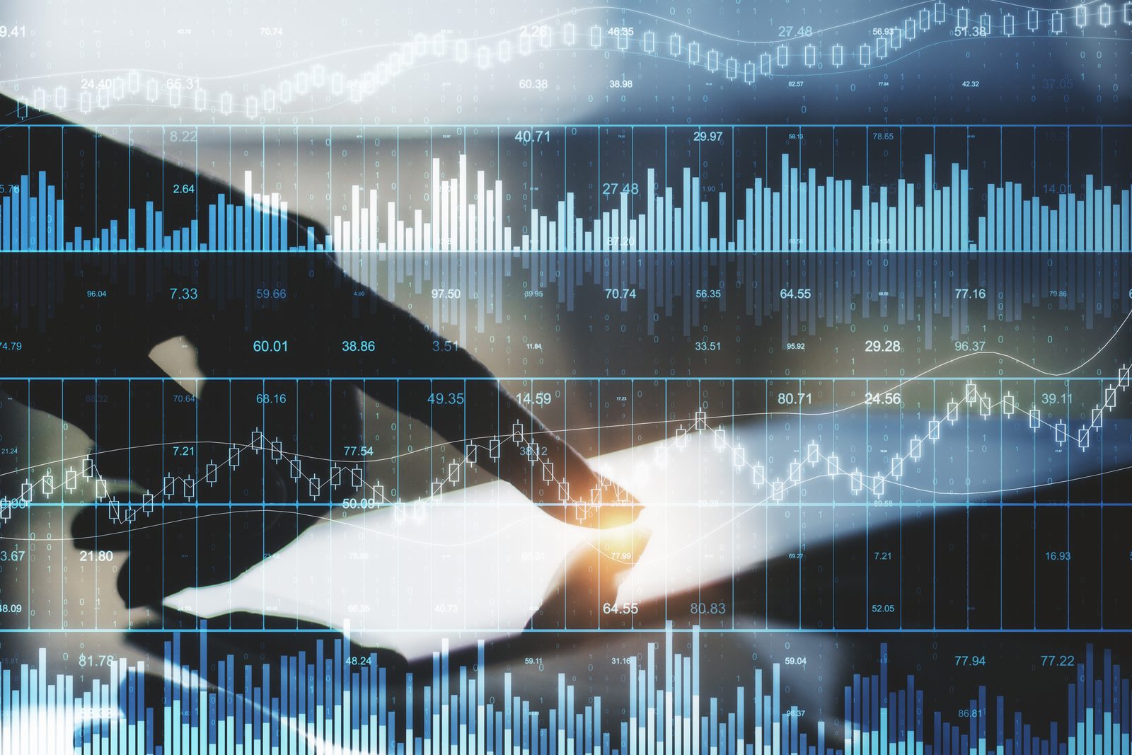 A hand reaching toward a screen of financial charts